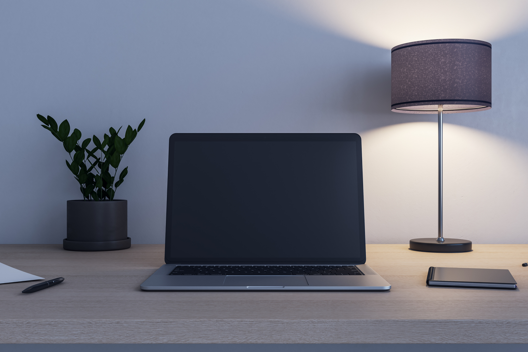 Front view on blank black modern laptop screen with place for your logo or text on wooden table with flowerpot, switched on lamp and notebook. 3D rendering, mock up